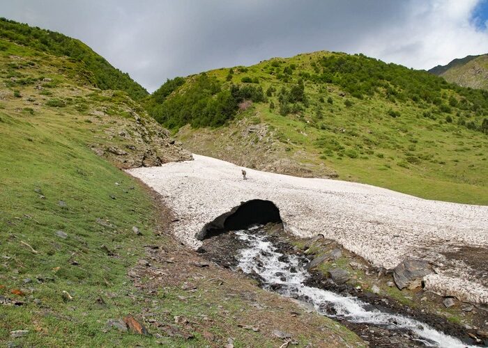 A hiker on the glacier during a hiking tour in Tusheti