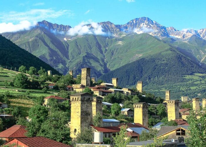 Svanetian defensive towers in Mestia with the Caucasus