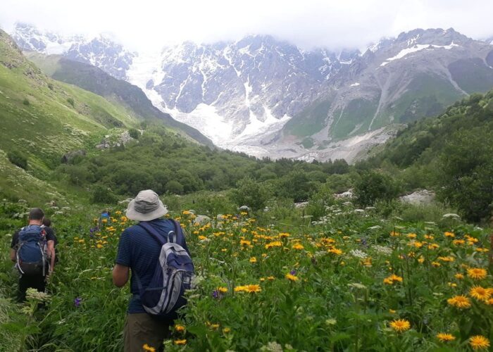 A tourist in the Shkhara Valley hiking from Mestia to Ushguli