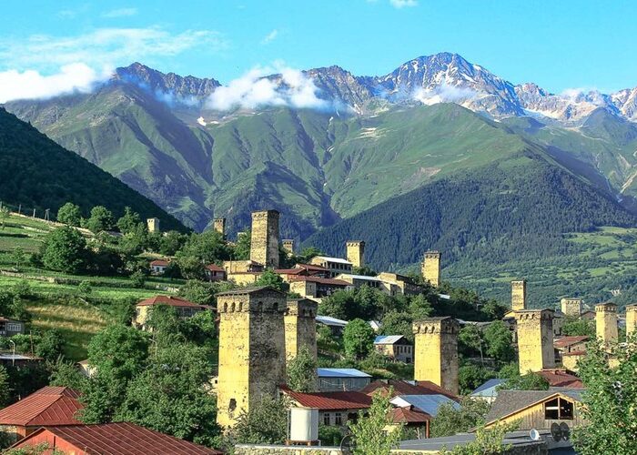 Svanetian towers in Mestia with the Caucasus