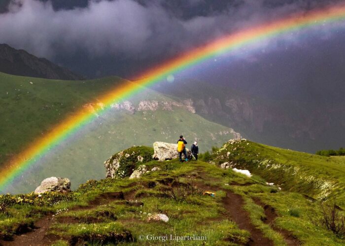 Tourist under A Rainbow in Stapntsminda